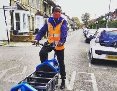 Turnham Green councillor Ron Mushiso making a delivery